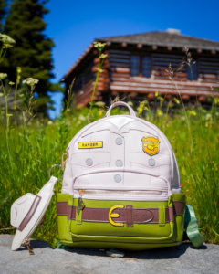 Ranger Trek Park Ranger Uniform Mini Backpack sitting in a field with a National Park building in the background.
